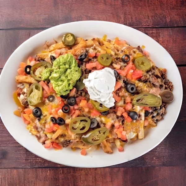 Loaded fries topped with melted cheese, ground beef, guacamole, sour cream, jalapeños, olives, and tomatoes.